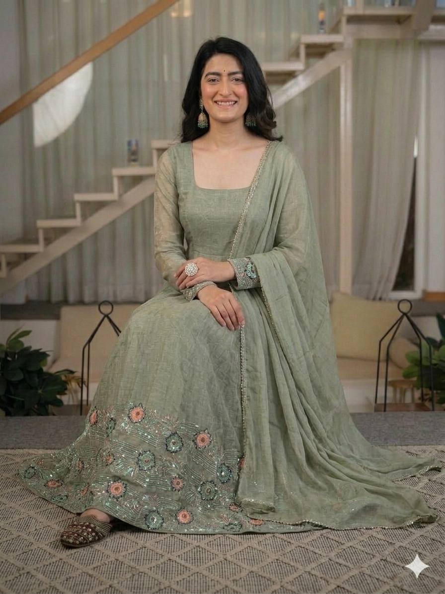 Ethereal Mehendi Green Flared Anarkali Suit Set Adorned with Luminous Sequined Floral Motifs, Embroidered Cuffs, and an Ornate Heritage Hem